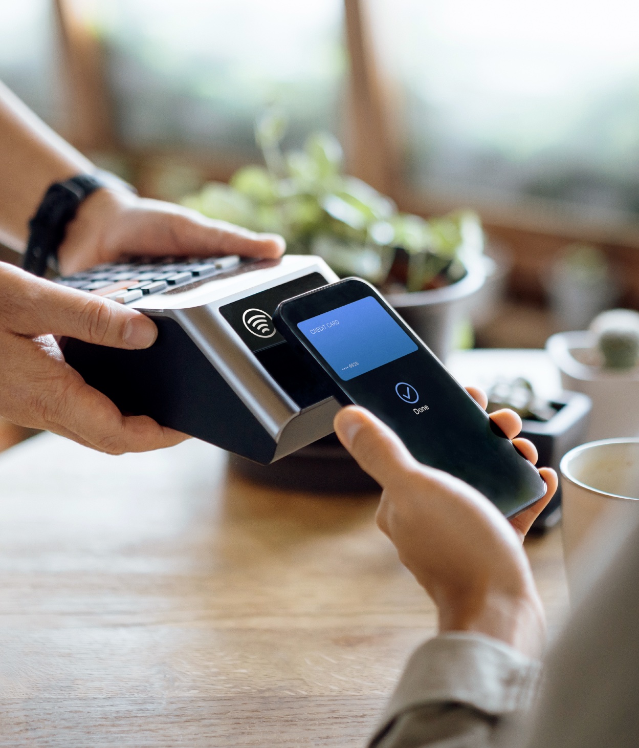 Woman holding a credit card as she shops online on a tablet computer.